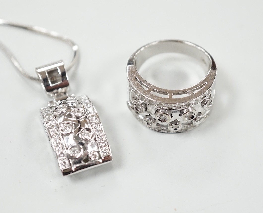 A modern 750 white metal and diamond cluster set dress ring, size N and a matching pendant necklace, 49cm, gross weight 21.8 grams.